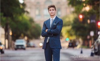 Young man in suit with crossed arms.