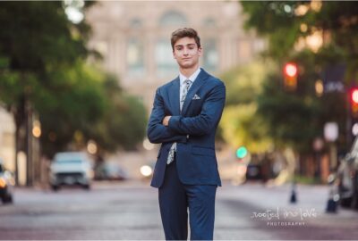 Young man in suit with crossed arms.